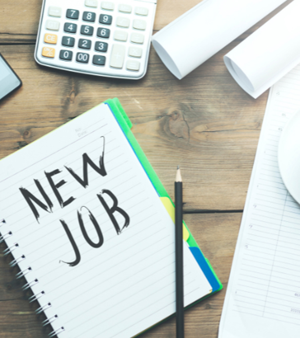 image of a desktop with calculator and a note pad with new job written on it